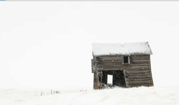 Image of wooden hut in the snow