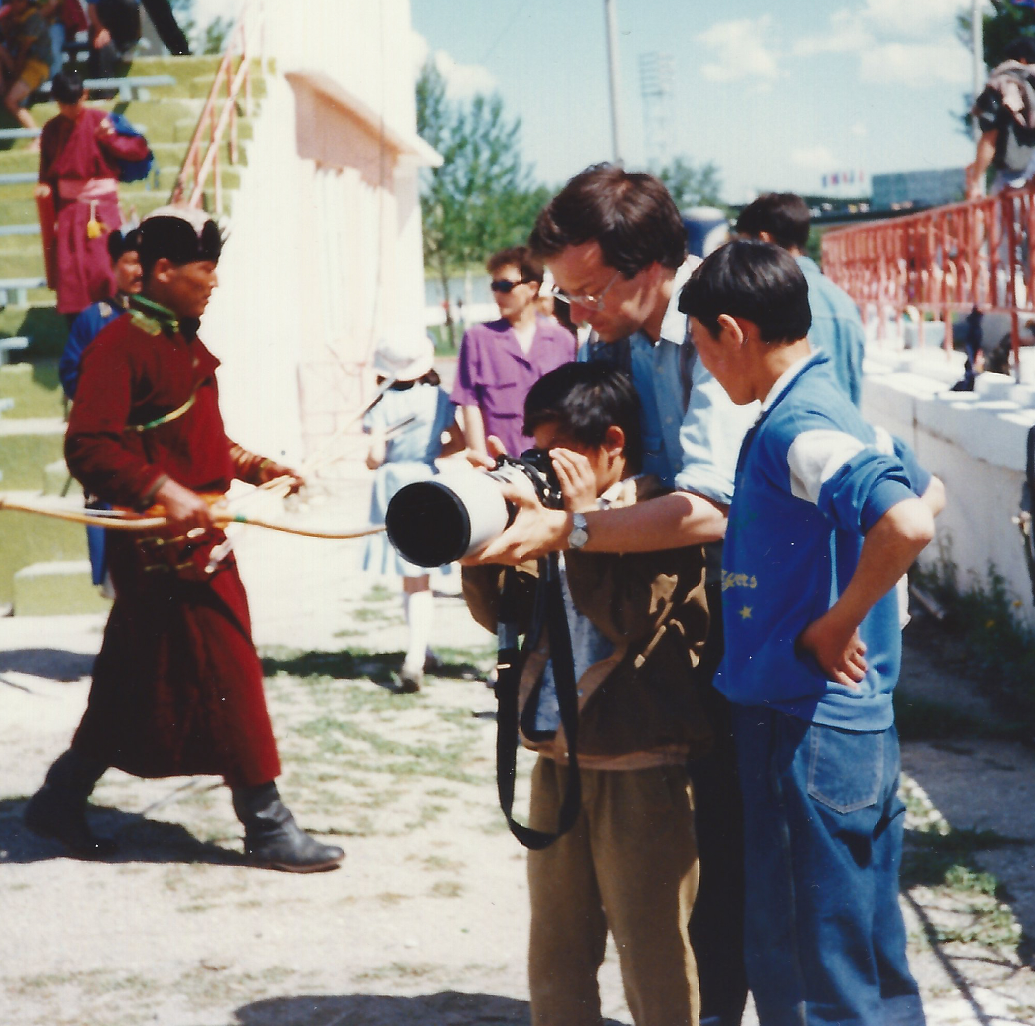 1993 Martin Keene shows his cameras to local children at the country’s Madam  Festival during a visit by the Princess Royal to Mongolia.