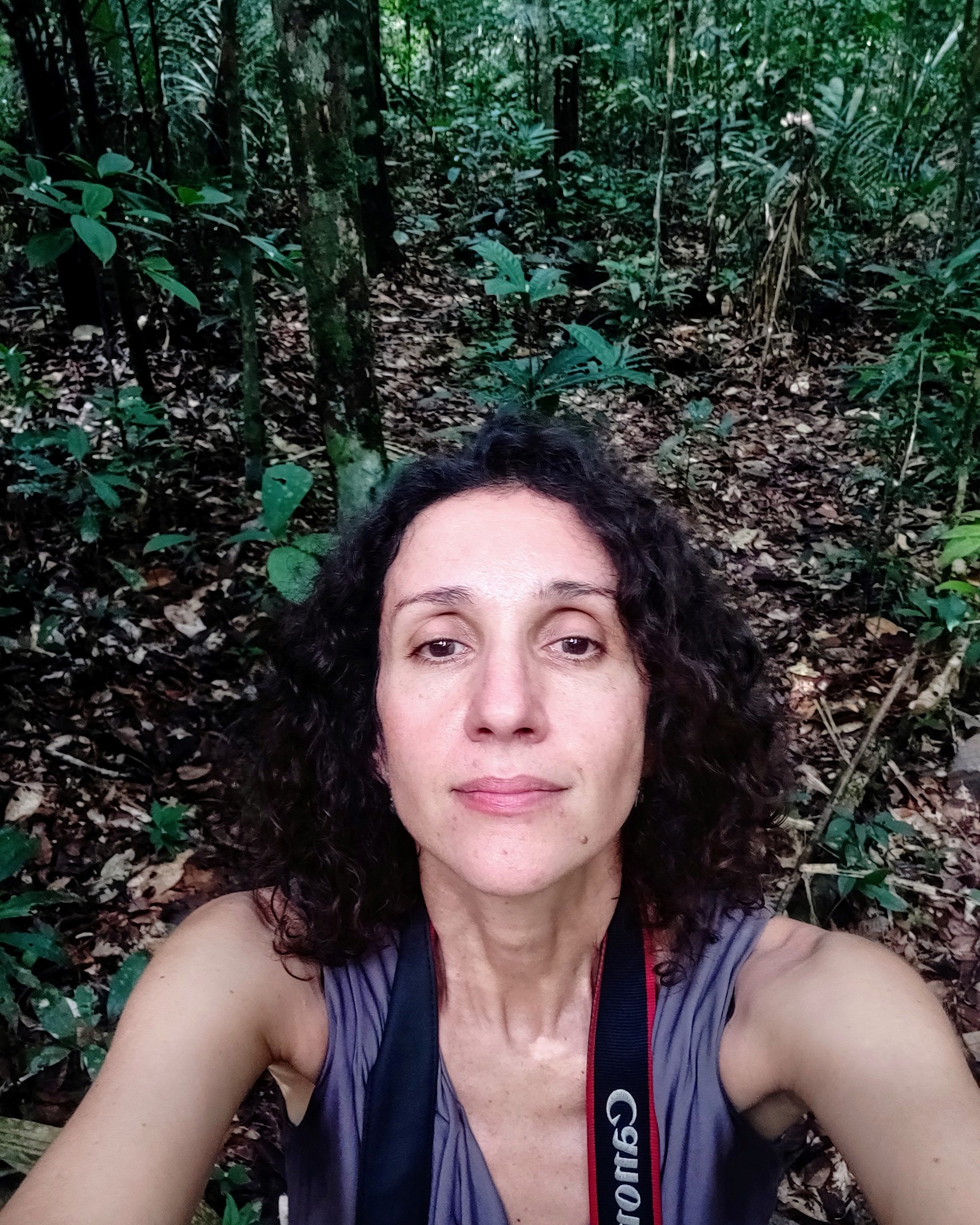 Leticia Valverdes in a jungle looking straight at camera with forest floor behind her