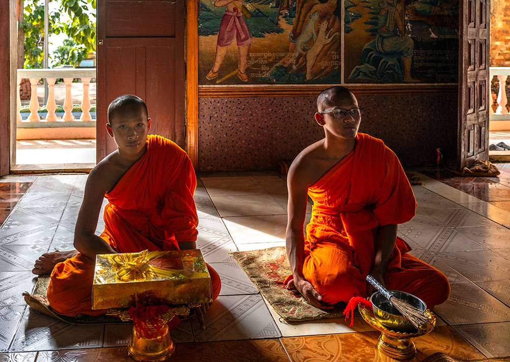 Blessing At Buddhist Temple, Cambodia by John Cavana