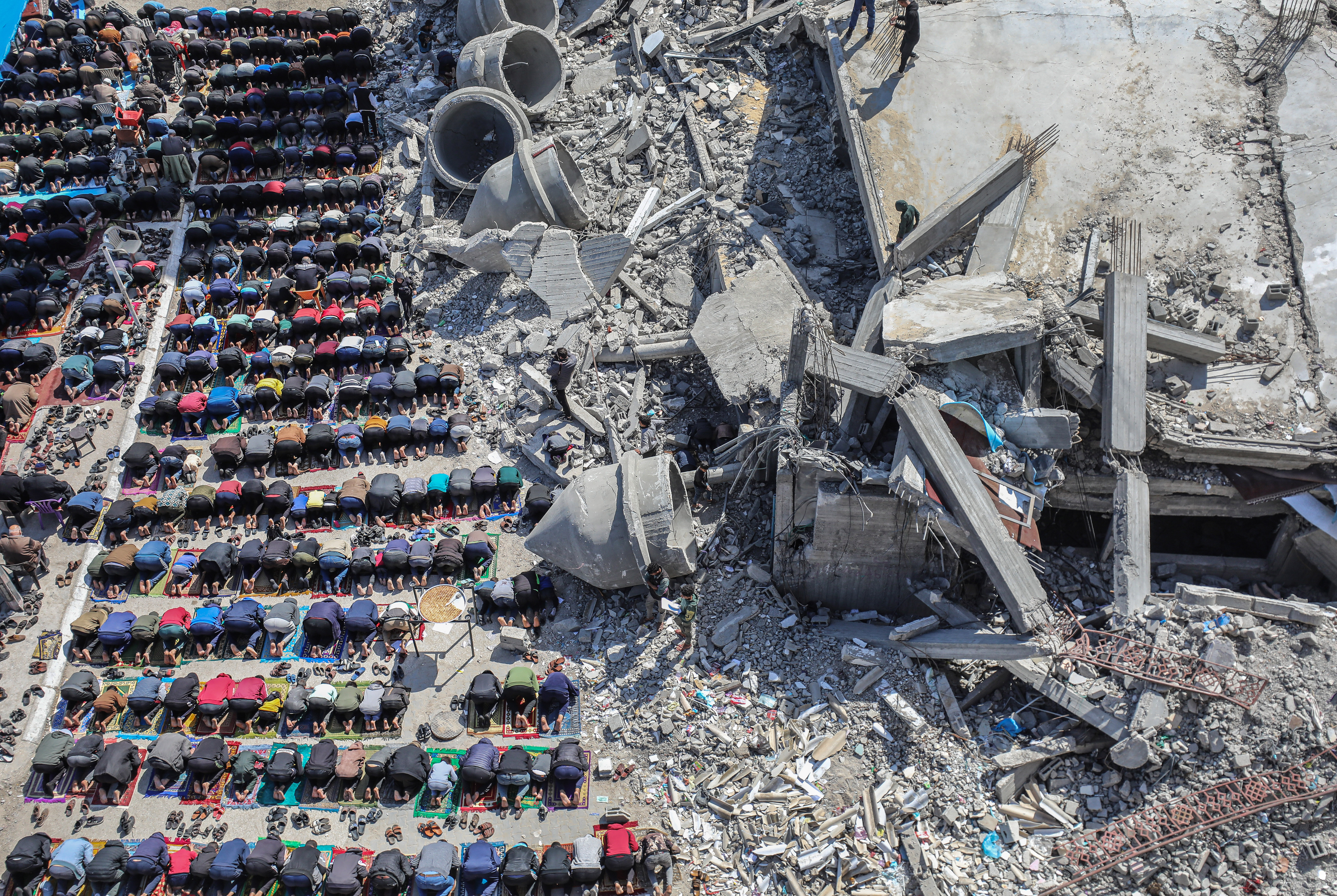 Praying in bombed debris