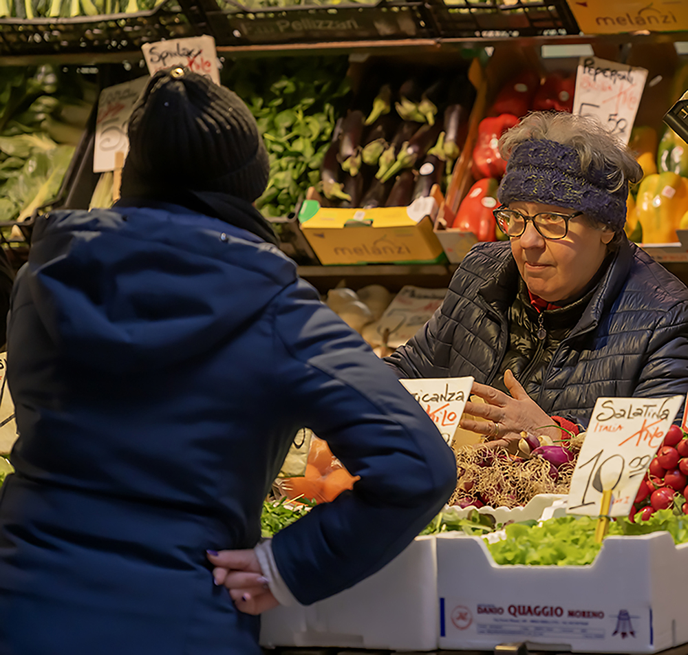 Greengrocer Giving Her Customer A Severe Listening To Market Area, Venice by John Speller