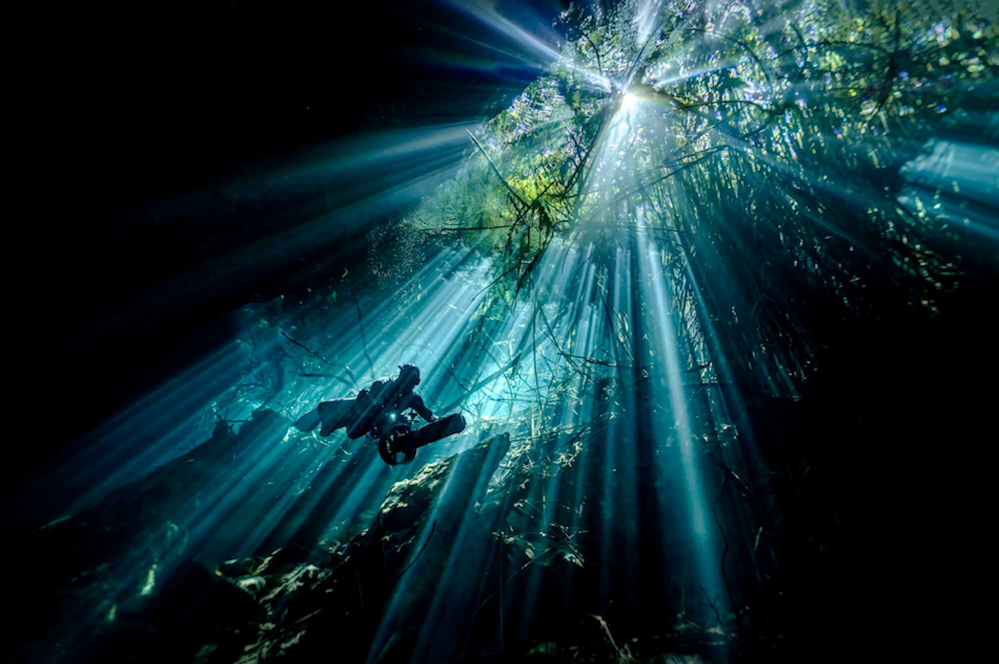 ‘The Narrow Entrance Of Cenote Corral Focuses The Pulsing Light Beams’ By Martin Broen
