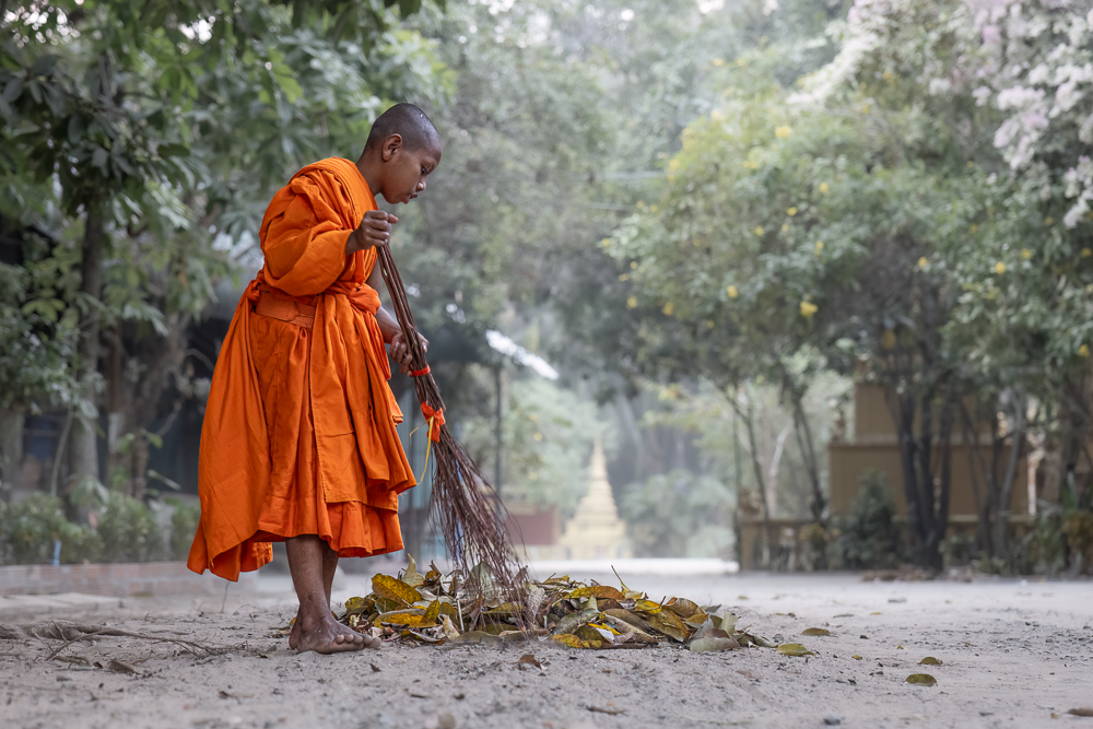 Monk Sweeping, Angkor, Cambodia by Russell Milner