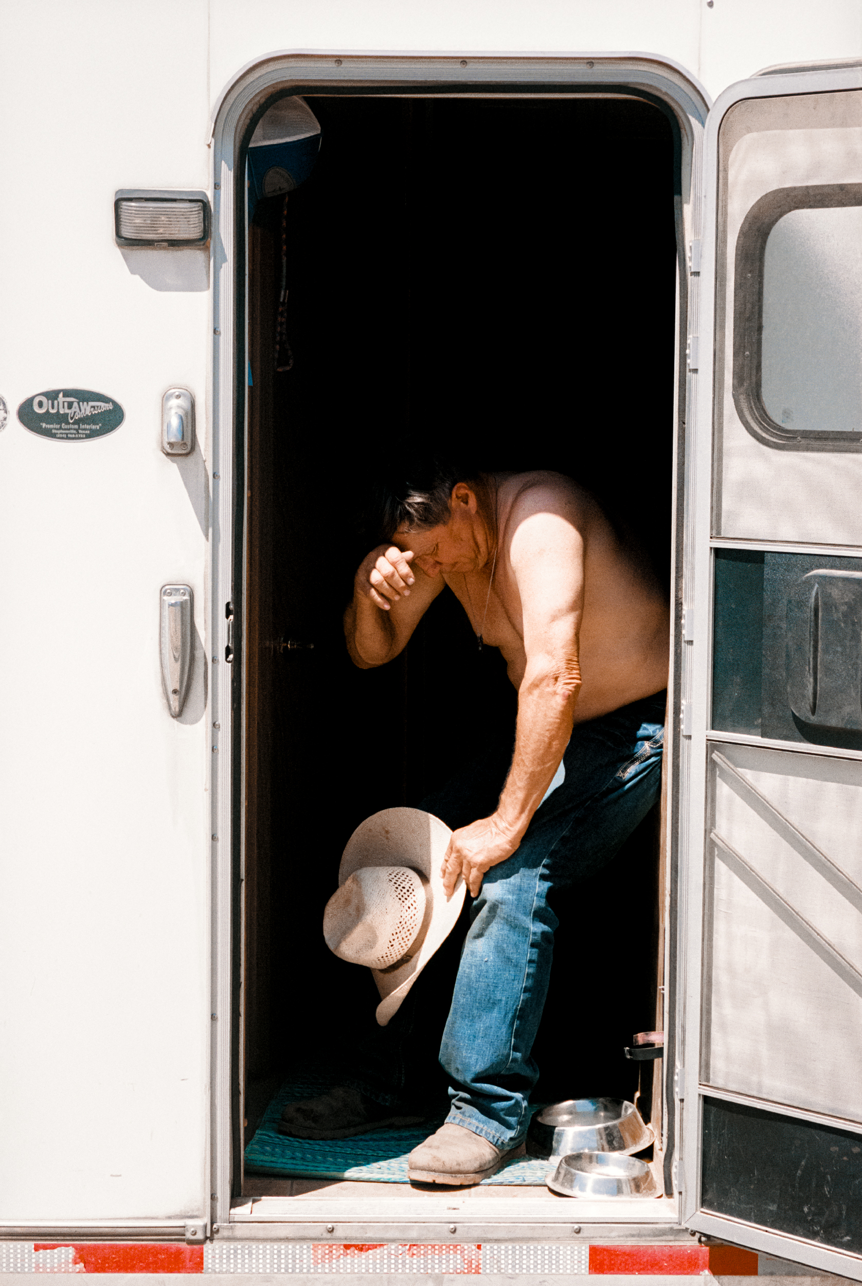 Tired cowboy in caravan 