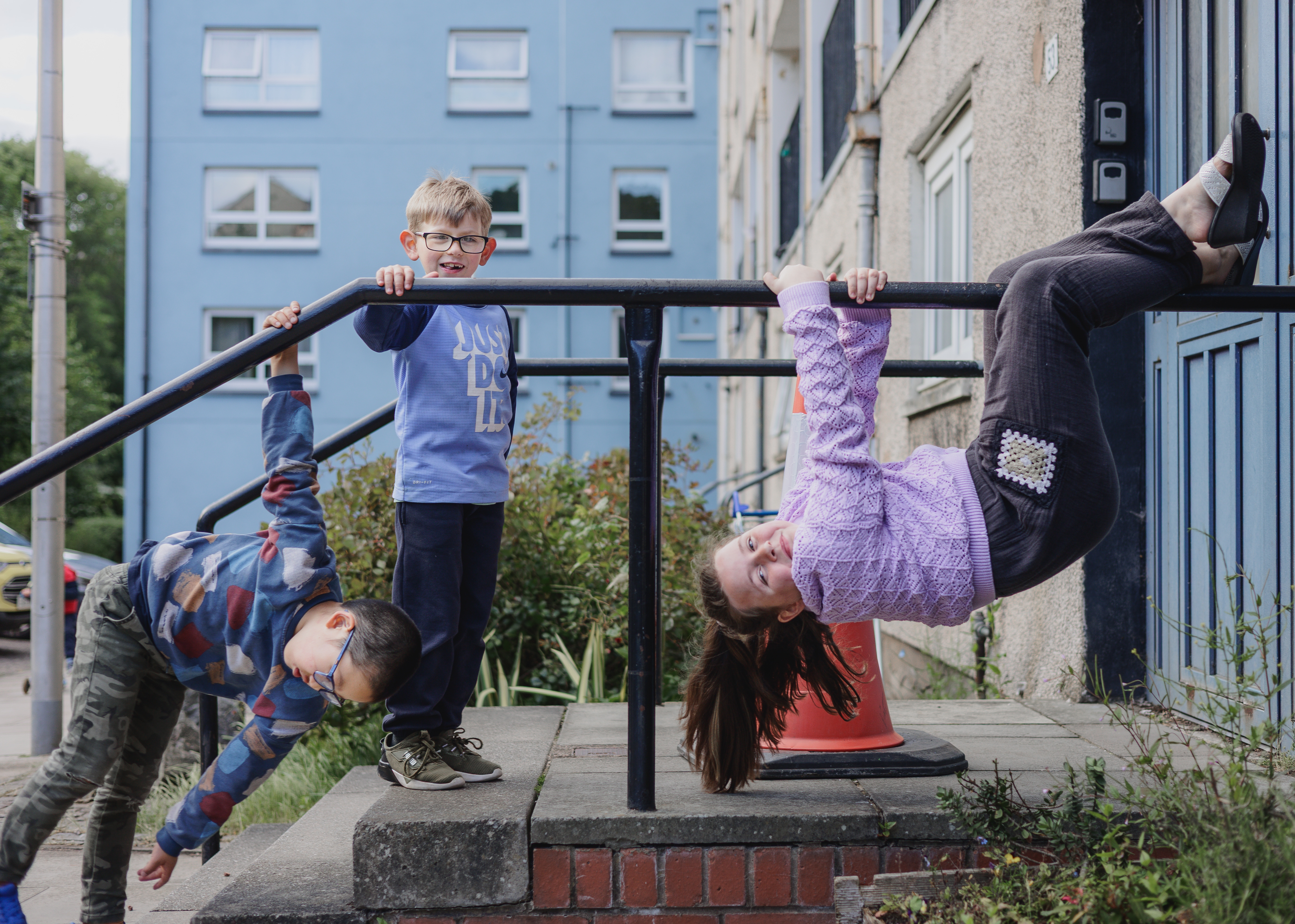 Children playing on railings 