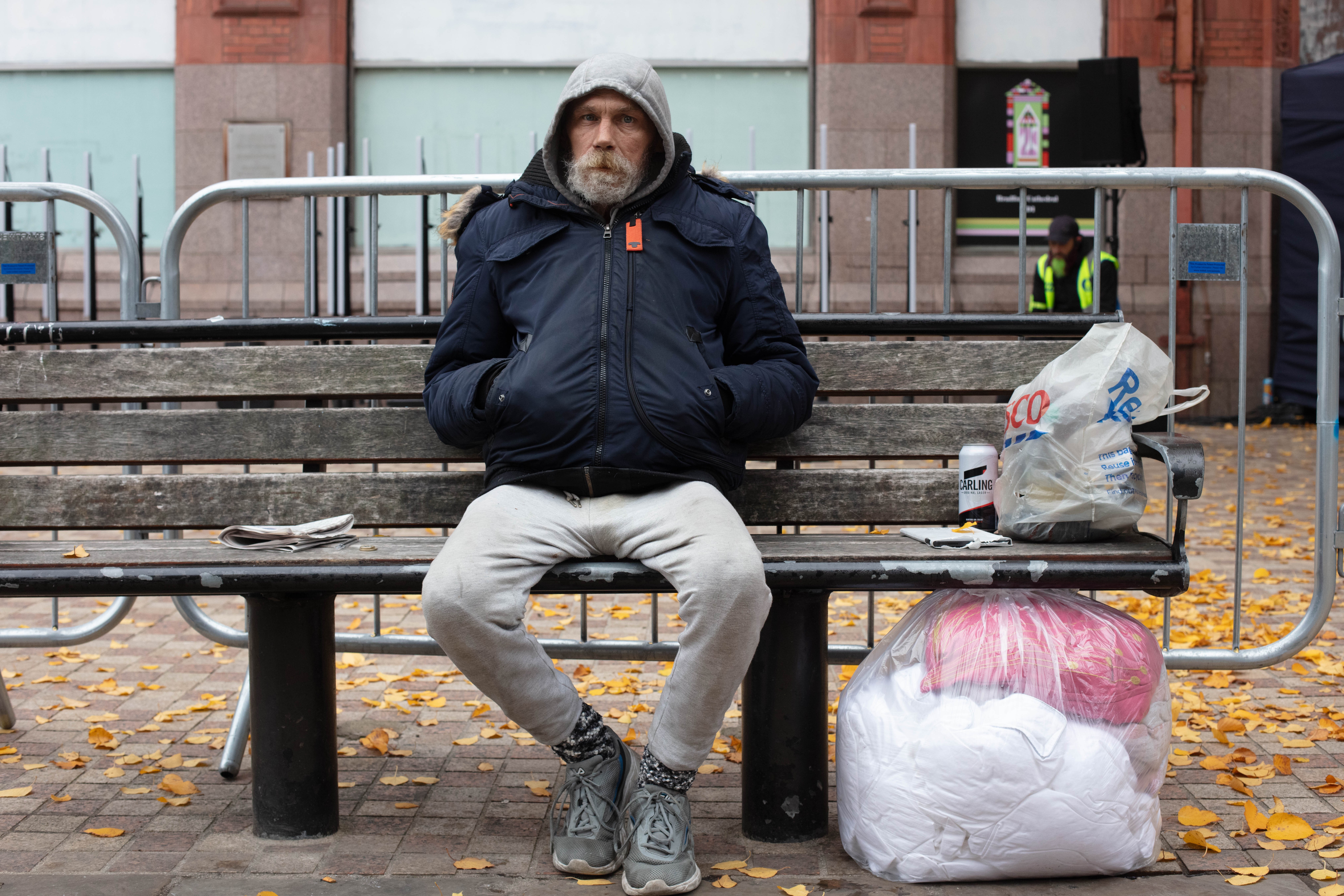 Homeless man sitting on a bench