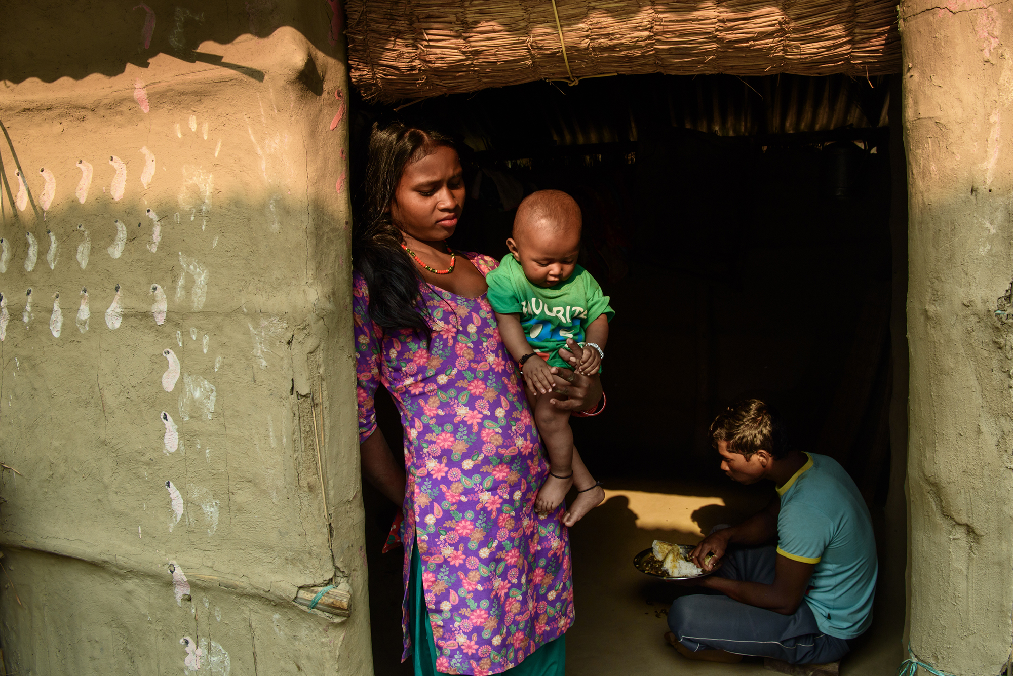 A young mother holds her baby