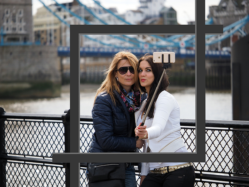 Two ladies taking a selfie, with cropping Ls over the image