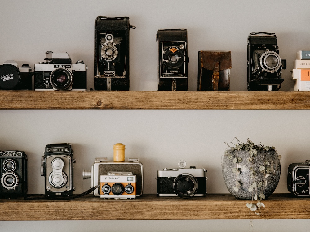 Analogue Cameras on shelves, By Annie Spratt For Unsplash