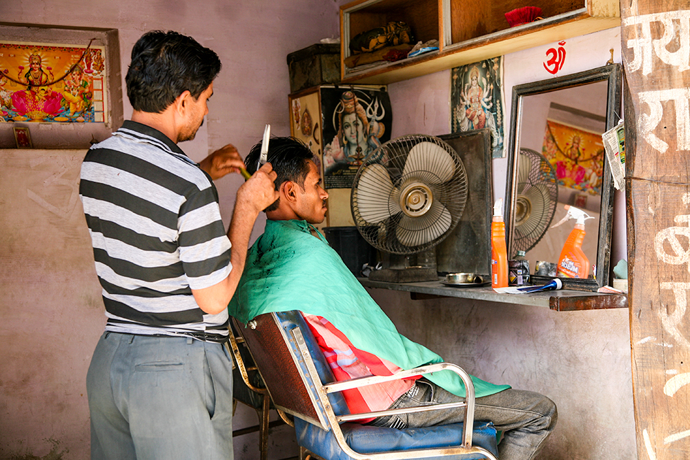 At The Hairdressers Nimaj, Rajasthan, India by Ruth Hanson